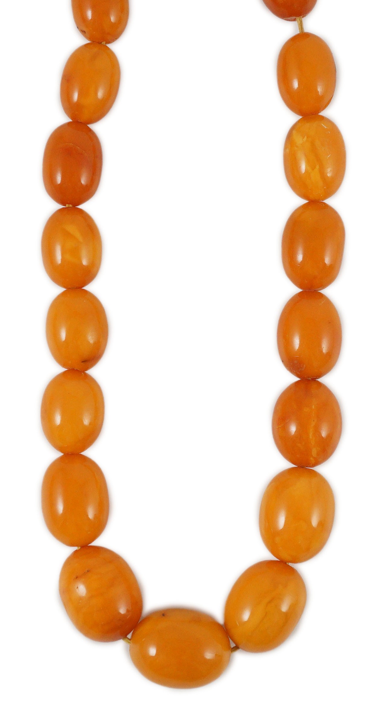 A single stand graduated oval amber bead necklace, 76cm, gross weight 85 grams.